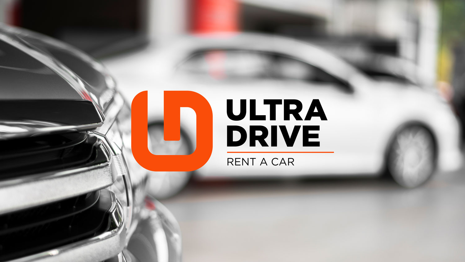 black and white car with the Ultra Drive logo over it, orange with black letters